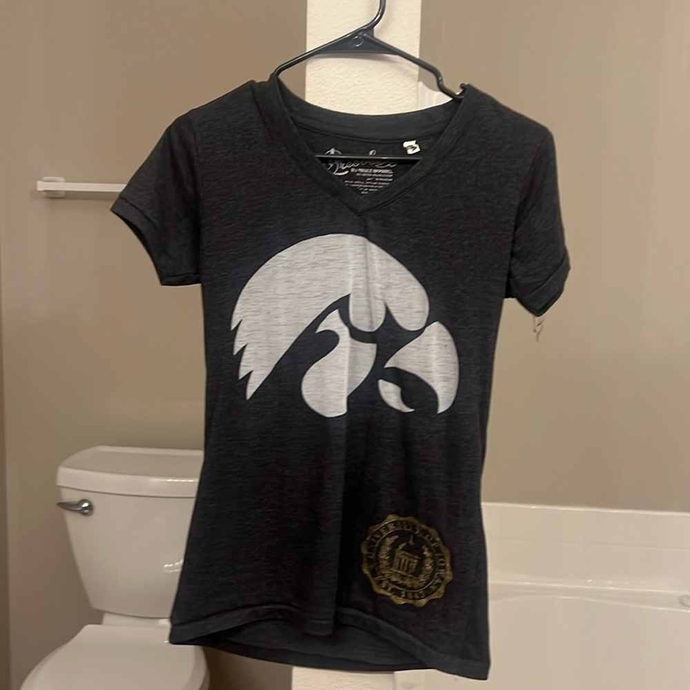 Fits like a small, form fitting light comfy soft material. Go hawks!